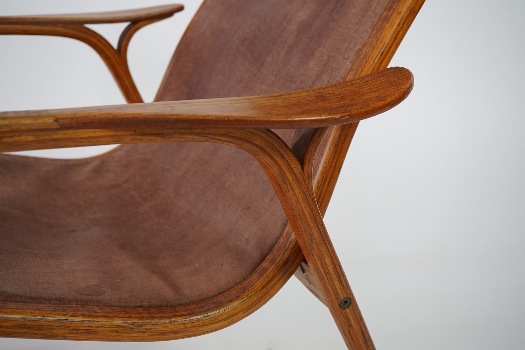 Yngve Ekström (Swedish, 1913-1998) for Swedese Möbler AB: A 'Lamino' oak lounge chair and ottoman
